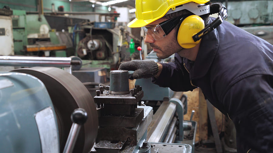 Workers operating CNC lathes